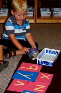 Primary Student Works With Traditional Montessori Materials